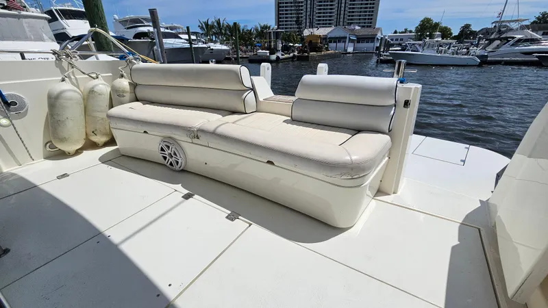  Yacht Photos Pics Sunseeker Manhattan 48 yacht deck with white seating, docked at marina, 1997 model.