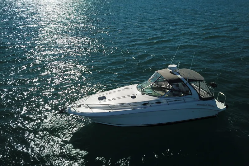 Good Juju Yacht Photos Pics 2005 Sea Ray 360 Sundancer yacht cruising on sparkling blue water.