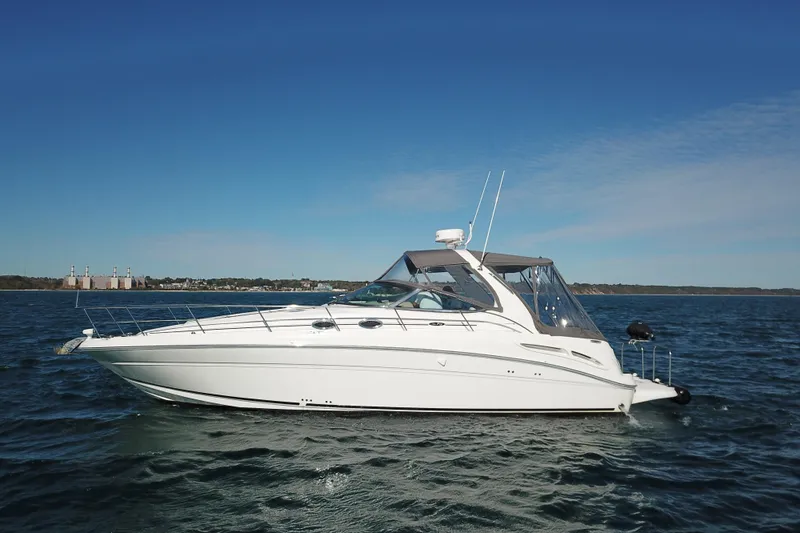 Good Juju Yacht Photos Pics 2005 Sea Ray 360 Sundancer yacht on open water under clear blue sky.