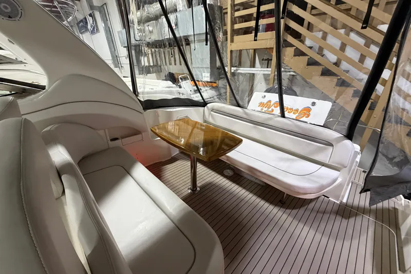 Good Juju Yacht Photos Pics Interior of 2005 Sea Ray 360 Sundancer with seating and wooden table.