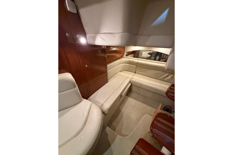 Good Juju Yacht Photos Pics Luxurious interior of 2005 Sea Ray 360 Sundancer with cream leather seating and wood accents.