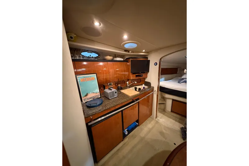 Good Juju Yacht Photos Pics 2005 Sea Ray 360 Sundancer interior with kitchenette and cozy sleeping area.
