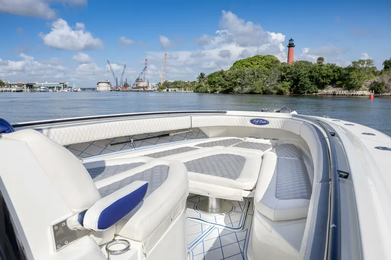 Dirty Deeds Yacht Photos Pics 2014 Hydra-Sports 42 Custom Siesta boat on scenic waterway with lighthouse view.
