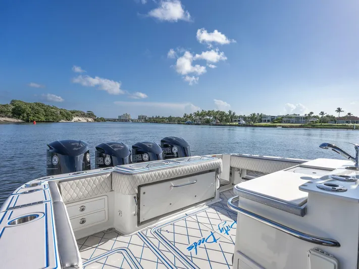 Dirty Deeds Yacht Photos Pics 2014 Hydra-Sports 42 Custom Siesta boat on calm water, clear sky, luxurious deck.