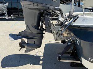 Outboard motor on 2007 Century 2202 BAY boat, docked in sunlight.