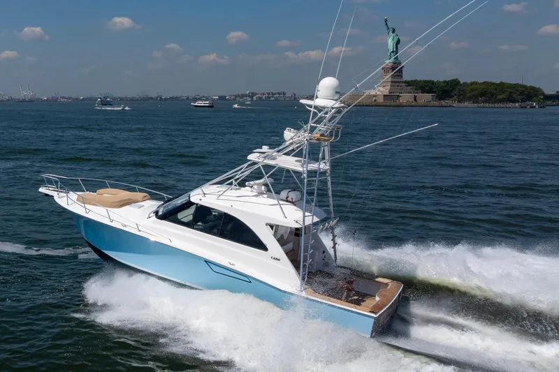  Yacht Photos Pics 2012 Cabo 44 Hardtop Express yacht cruising near Statue of Liberty.