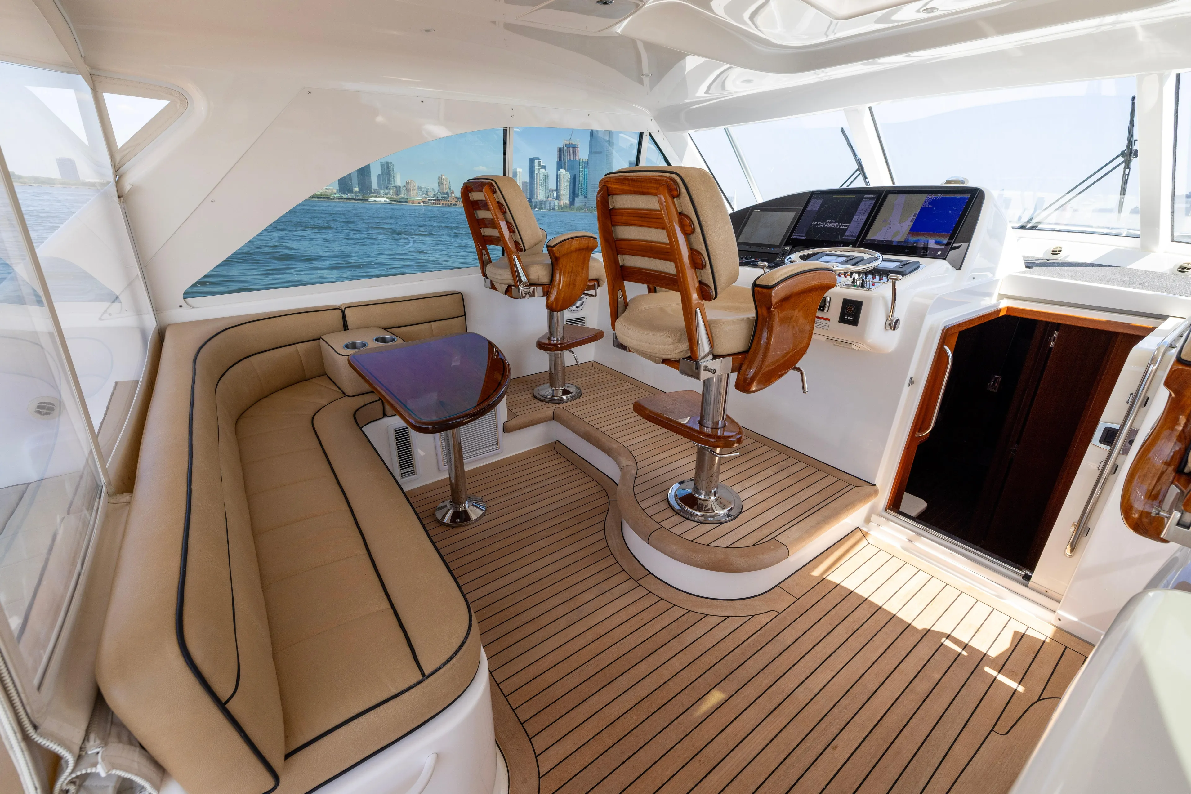  Yacht Photos Pics Luxurious 2012 Cabo 44 Hardtop Express yacht interior with plush seating and modern helm.