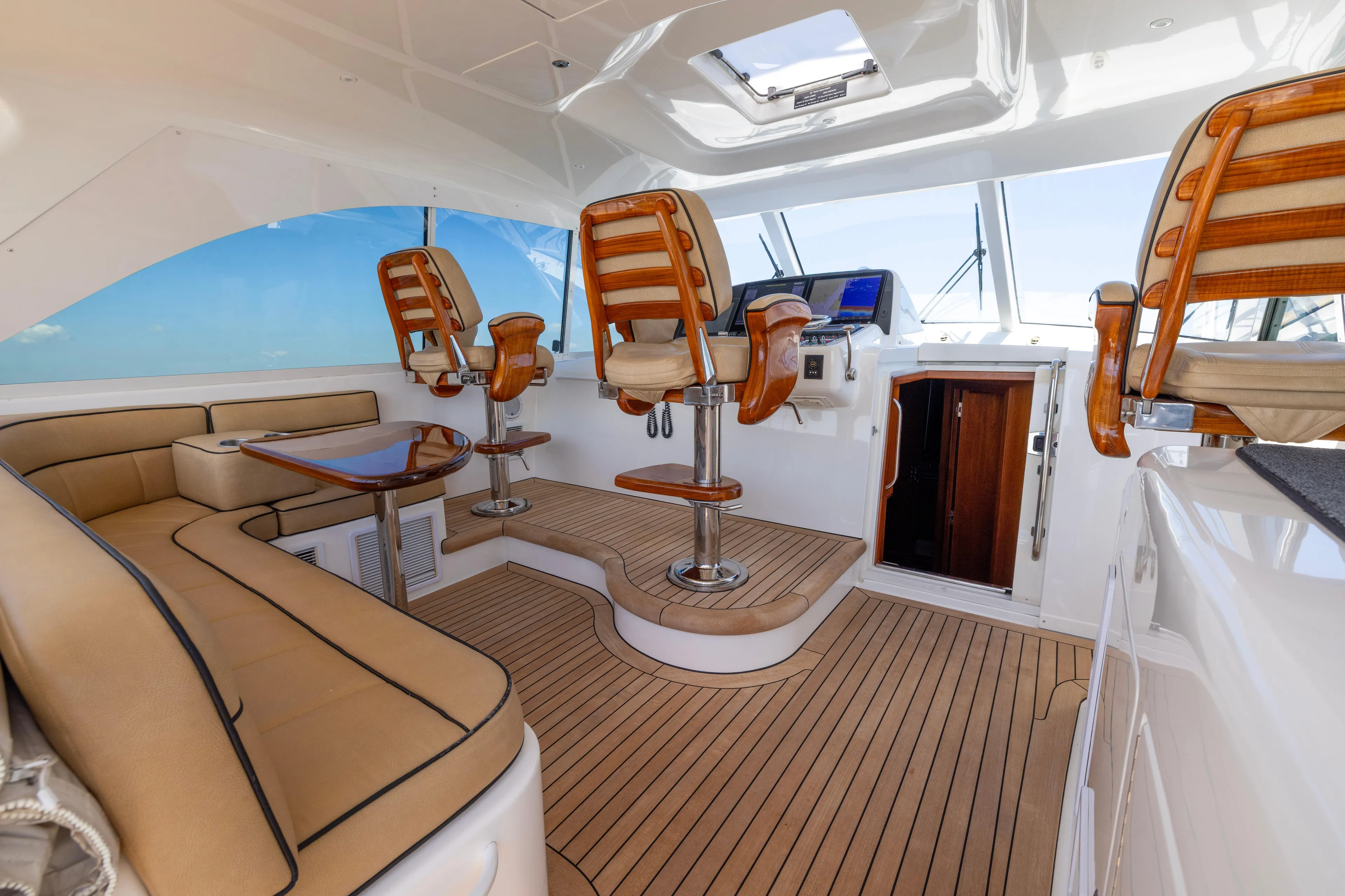  Yacht Photos Pics Luxurious interior of 2012 Cabo 44 Hardtop Express yacht with elegant seating and helm.