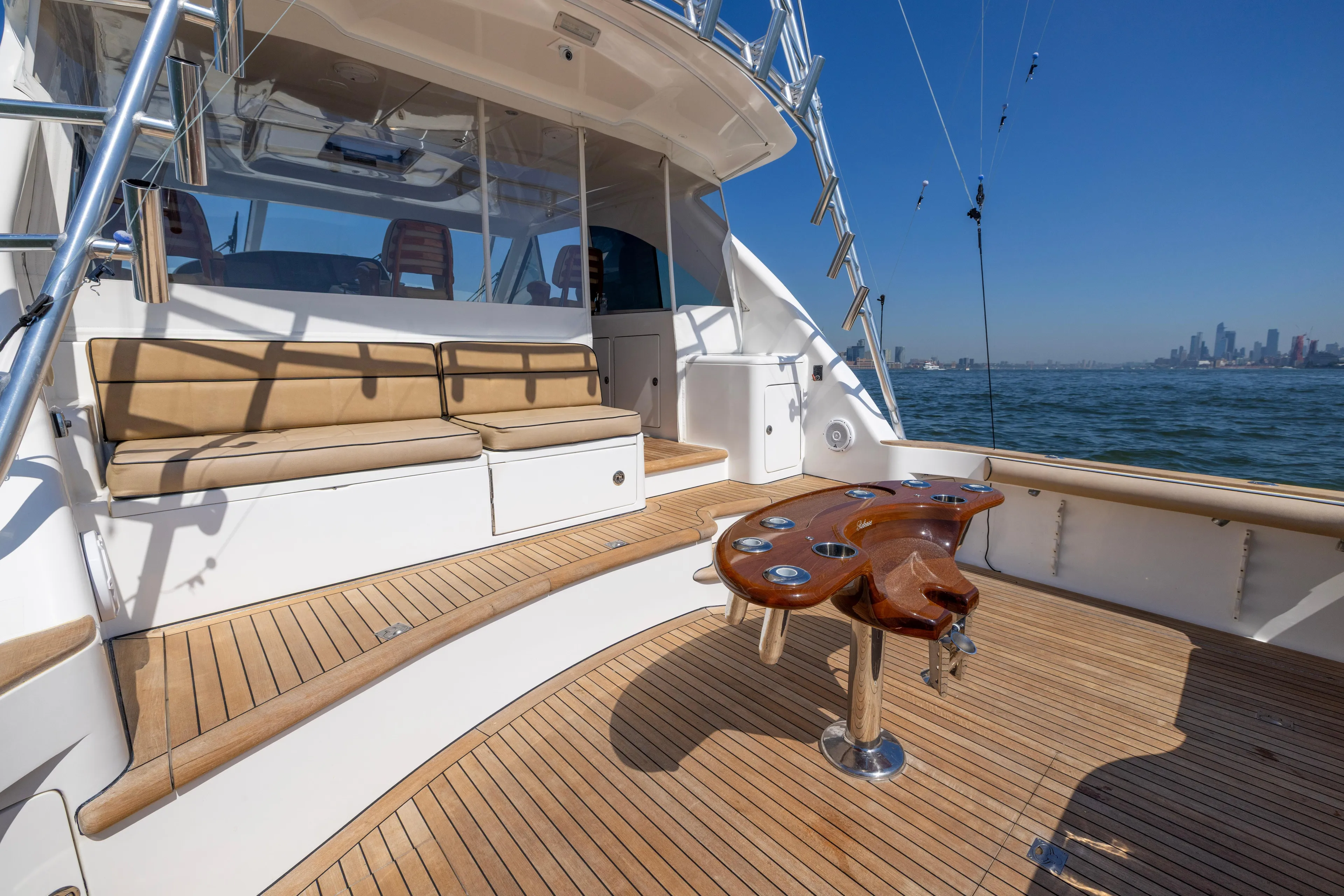  Yacht Photos Pics Luxurious 2012 Cabo 44 Hardtop Express yacht with spacious deck and city skyline view.