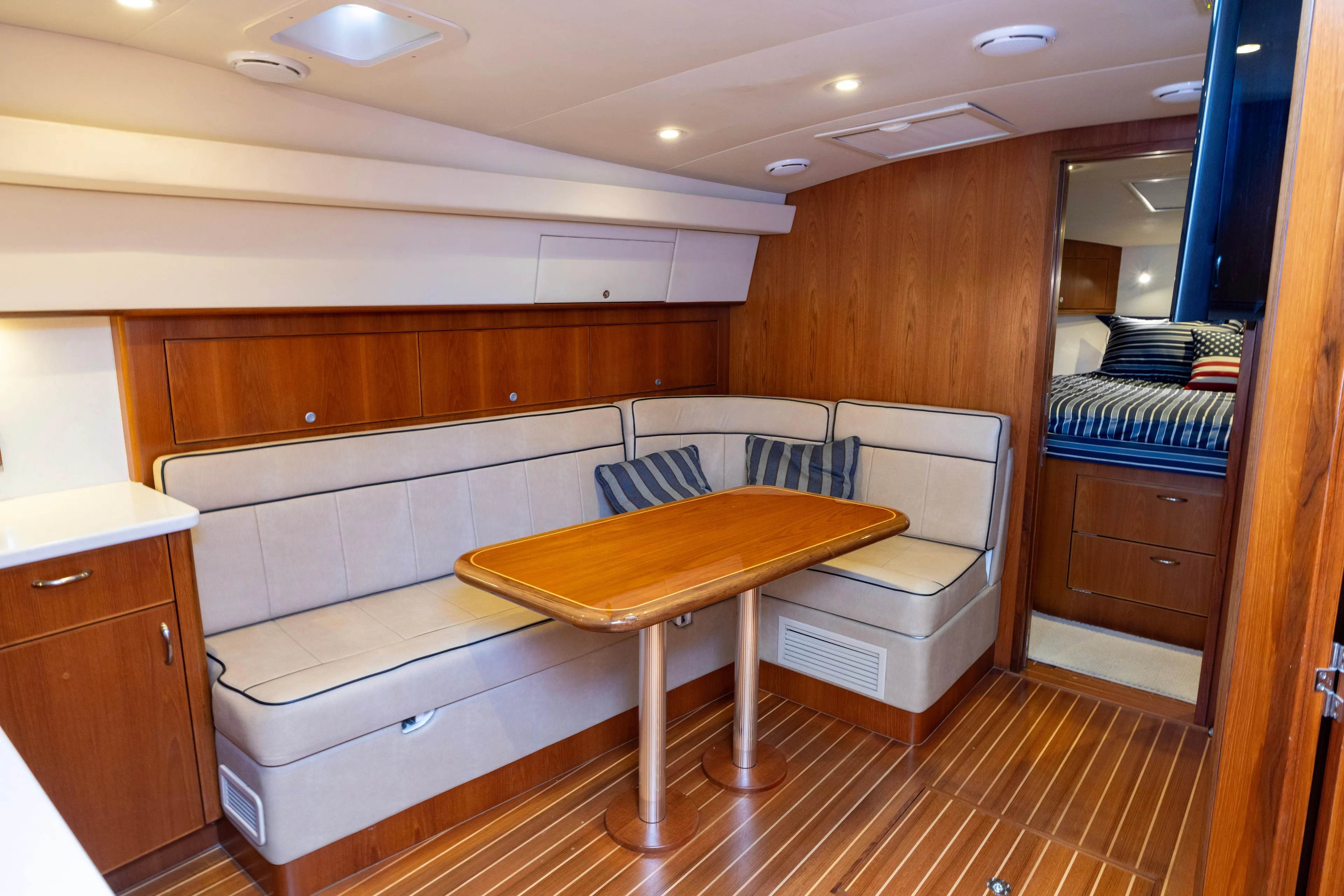 Yacht Photos Pics Luxurious interior of 2012 Cabo 44 Hardtop Express yacht with elegant wood finishes.