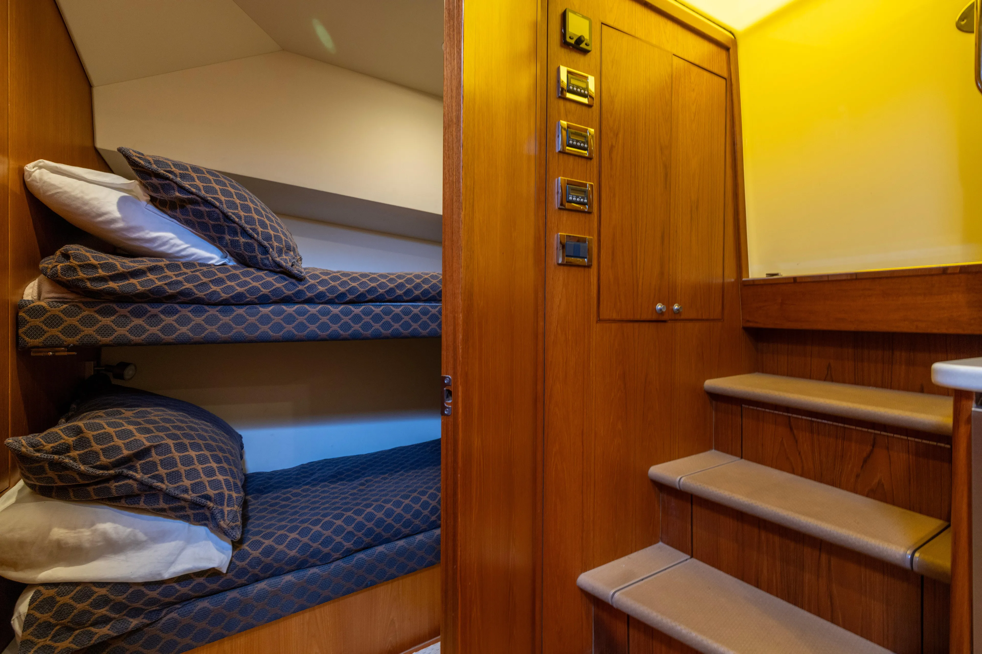  Yacht Photos Pics Interior of 2012 Cabo 44 Hardtop Express with cozy bunk beds and wooden stairs.