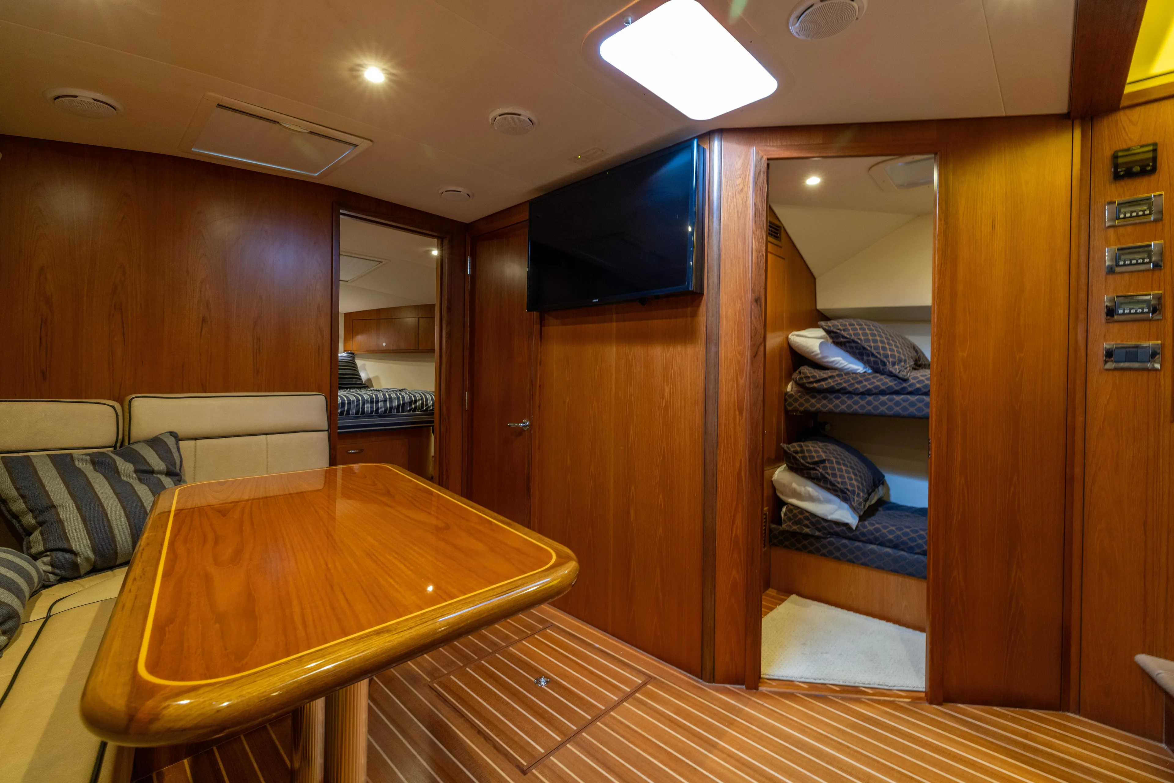  Yacht Photos Pics Luxurious interior of 2012 Cabo 44 Hardtop Express yacht with wood finish and cozy seating.