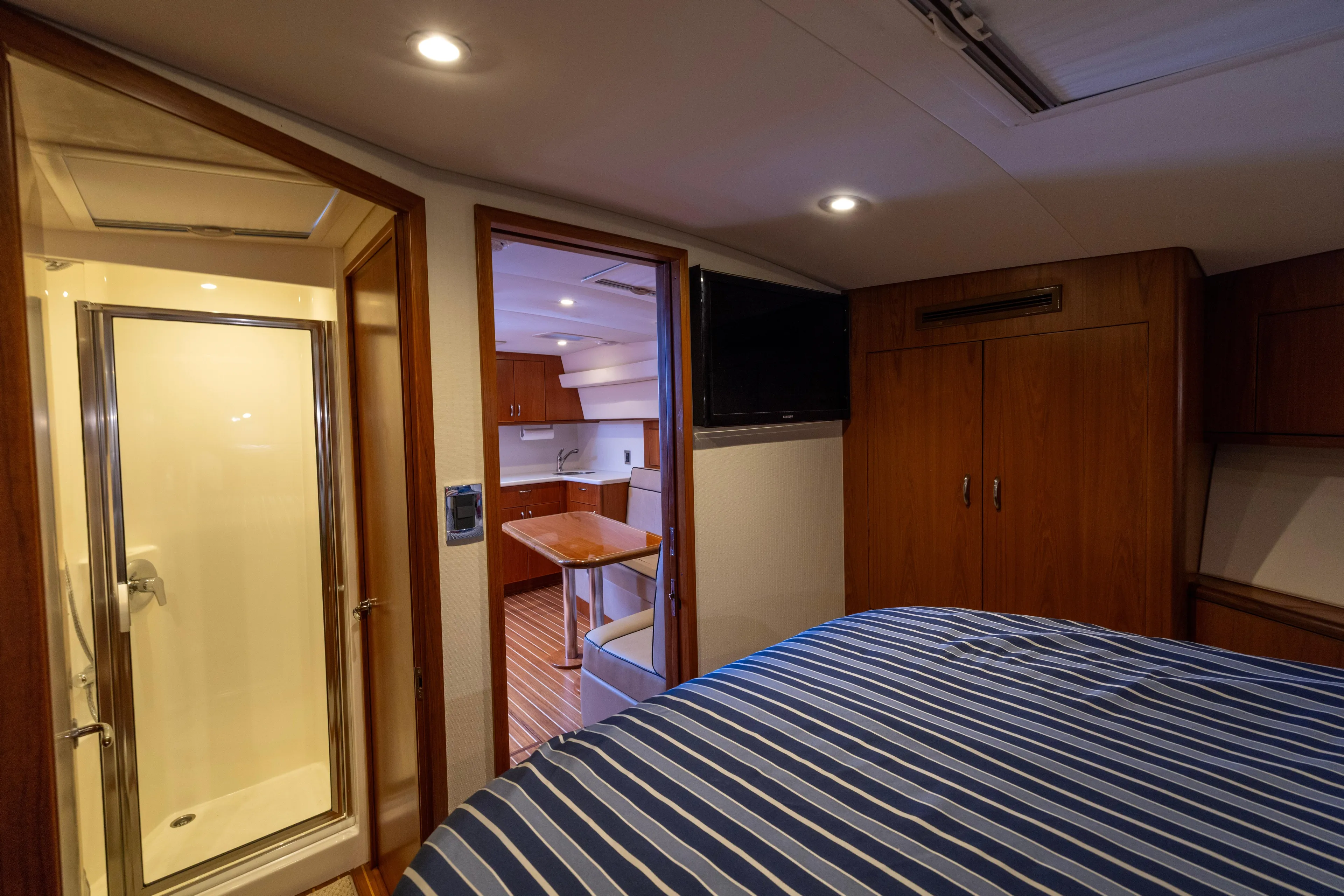  Yacht Photos Pics 2012 Cabo 44 Hardtop Express interior with bedroom, bathroom, and kitchenette.