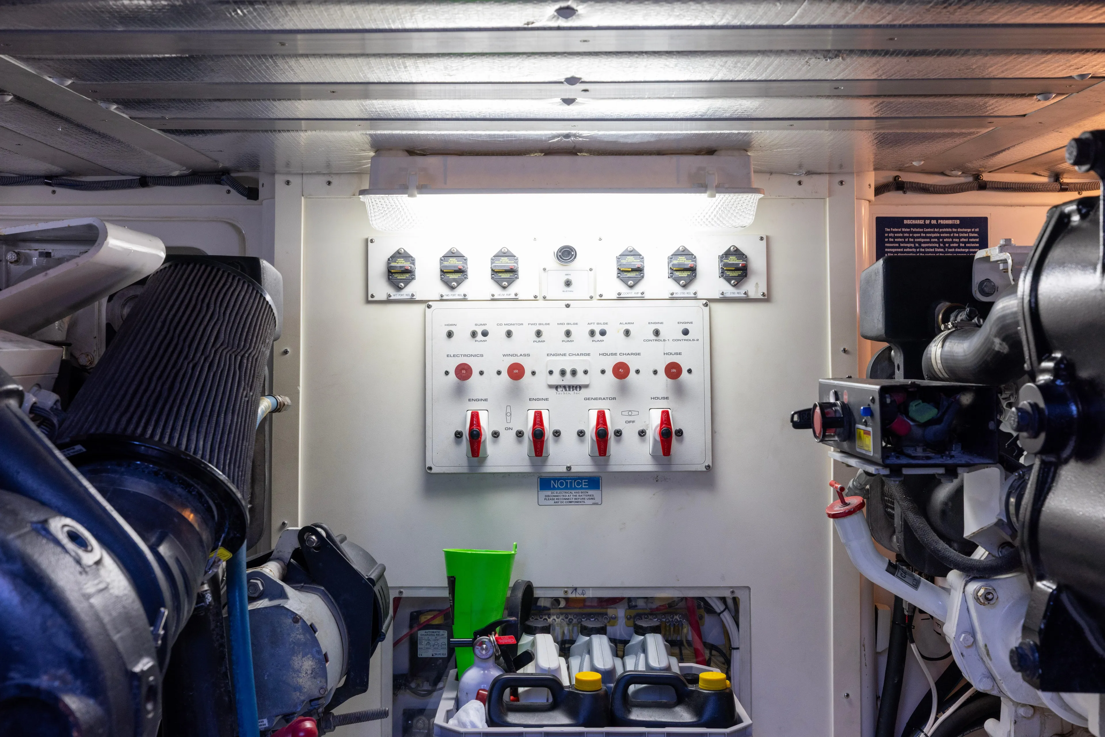  Yacht Photos Pics Engine room of 2012 Cabo 44 Hardtop Express with control panel and machinery.