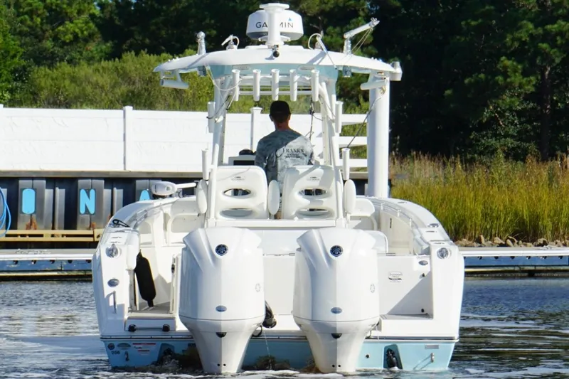  Yacht Photos Pics 2020 Cobia 301 Center Console boat with dual engines on a calm waterway.