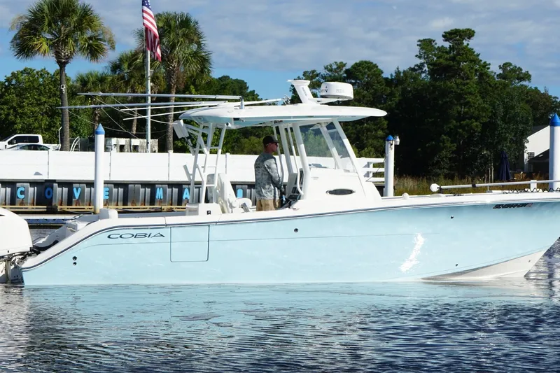  Yacht Photos Pics 2020 Cobia 301 Center Console boat docked at marina with palm trees.