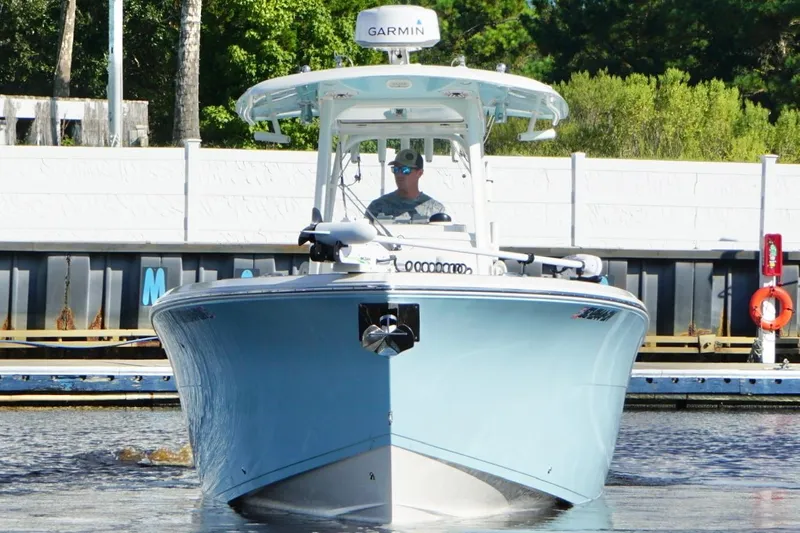  Yacht Photos Pics 2020 Cobia 301 Center Console boat on water, front view, with Garmin equipment.