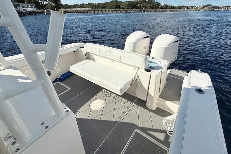 Yacht Photos Pics 2020 Cobia 301 Center Console boat with dual engines on a serene waterway.