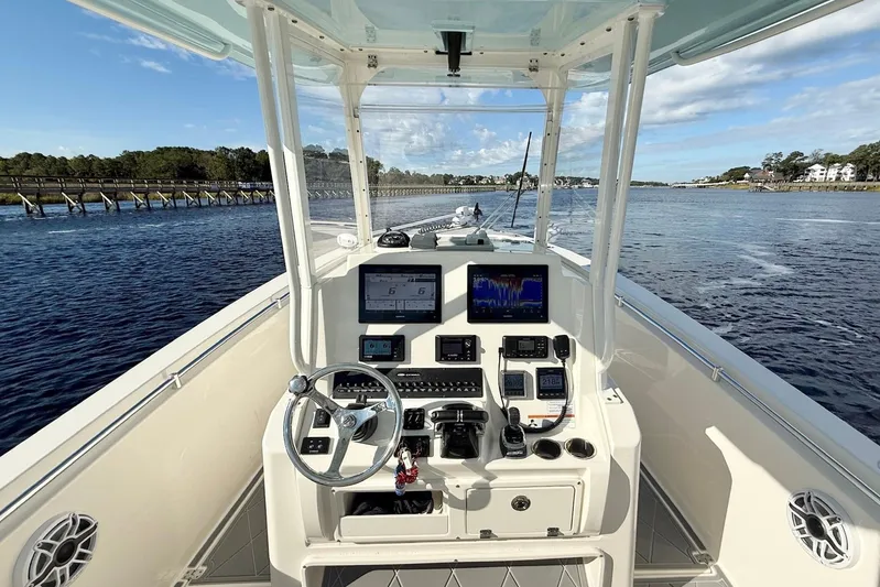  Yacht Photos Pics 2020 Cobia 301 Center Console boat dashboard with navigation screens on open water.