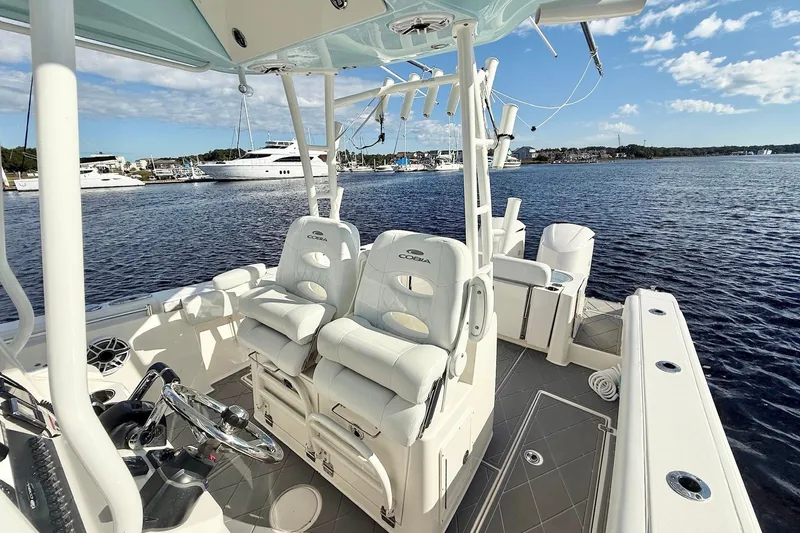  Yacht Photos Pics 2020 Cobia 301 Center Console boat interior with dual seats, docked by the water.