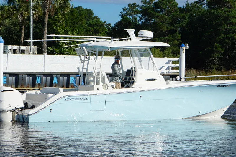  Yacht Photos Pics 2020 Cobia 301 Center Console boat on water near marina, clear day.