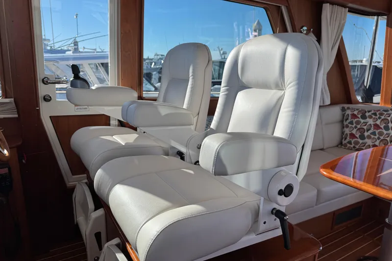 Dot's Deal Yacht Photos Pics Luxurious interior of 2023 Sabre 48 Salon Express with plush seating and wooden accents.