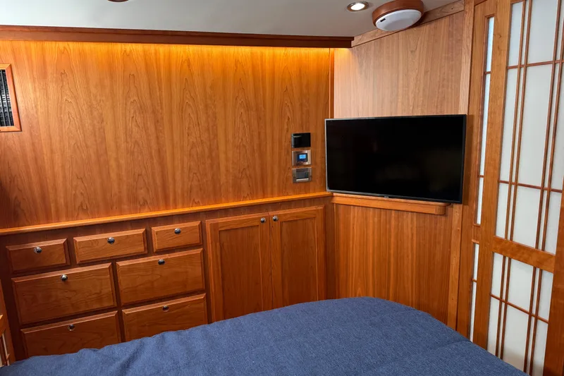Dot's Deal Yacht Photos Pics Luxurious 2023 Sabre 48 Salon Express interior with wood paneling and mounted TV.