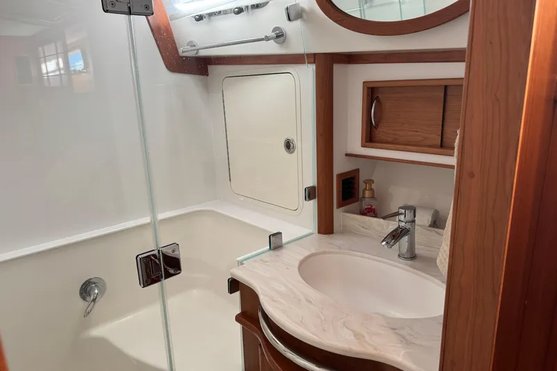 Dot's Deal Yacht Photos Pics 2023 Sabre 48 Salon Express bathroom with modern sink and shower design.