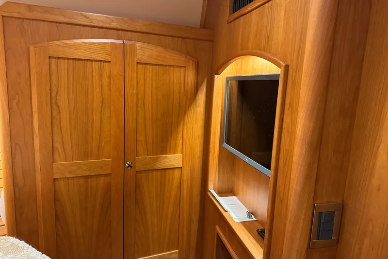Dot's Deal Yacht Photos Pics 2023 Sabre 48 Salon Express interior with wooden cabinetry and built-in TV.