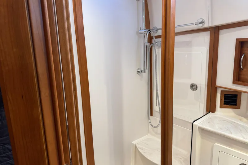 Dot's Deal Yacht Photos Pics 2023 Sabre 48 Salon Express bathroom with wooden accents and modern shower.