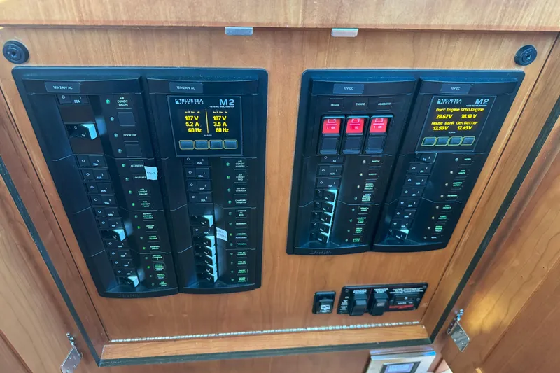 Dot's Deal Yacht Photos Pics Electrical control panel on 2023 Sabre 48 Salon Express yacht, featuring multiple switches and displays.