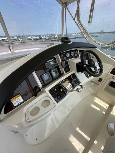  Yacht Photos Pics 2006 Carver 38 Super Sport helm with navigation instruments and steering wheel, dockside view.