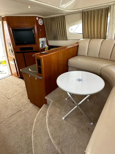  Yacht Photos Pics Interior of 2006 Carver 38 Super Sport yacht with beige seating and a small round table.