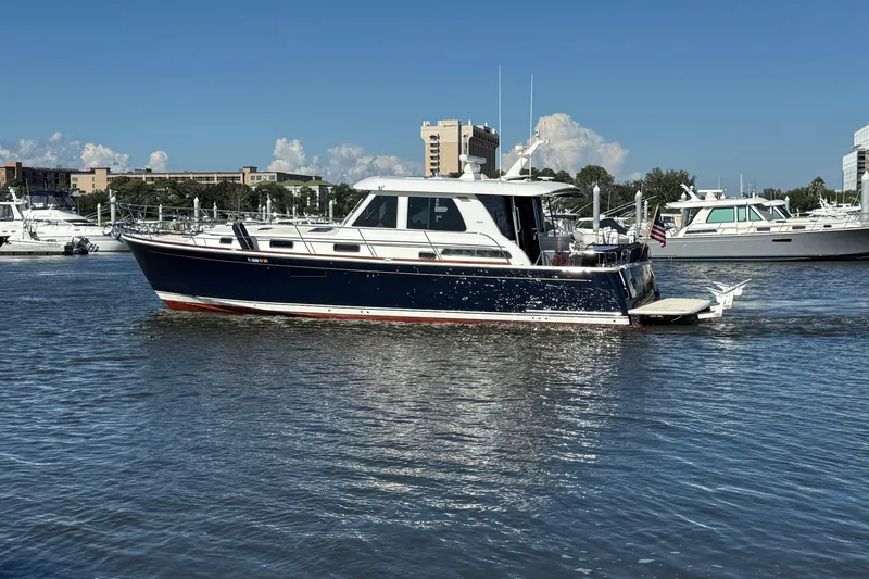 Haggis Xx Yacht Photos Pics 2017 Sabre 48 Salon Express yacht cruising in a marina under a clear blue sky.