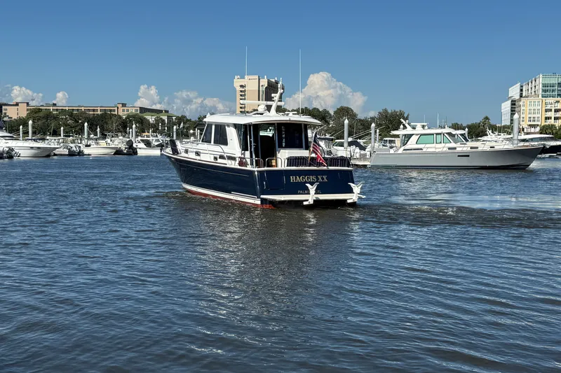 Haggis Xx Yacht Photos Pics 2017 Sabre 48 Salon Express yacht cruising in a marina with other boats.