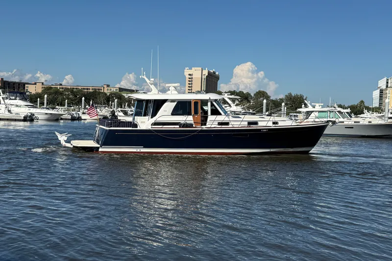 Haggis Xx Yacht Photos Pics 2017 Sabre 48 Salon Express yacht cruising in a marina under a clear blue sky.