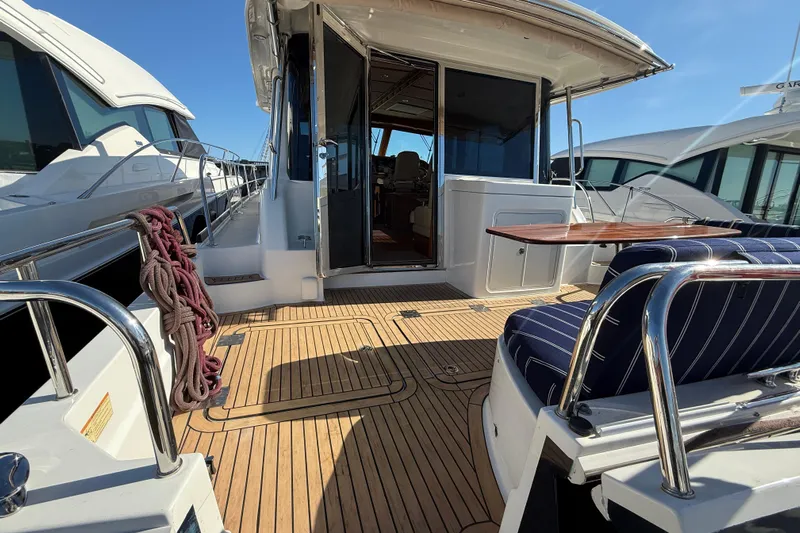 Haggis Xx Yacht Photos Pics 2017 Sabre 48 Salon Express yacht deck with seating and table, docked beside other boats.