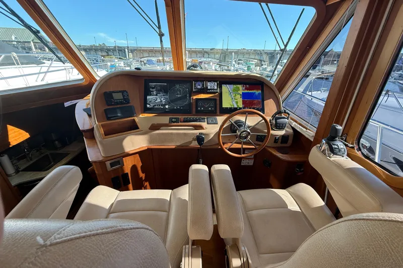 Haggis Xx Yacht Photos Pics 2017 Sabre 48 Salon Express helm with navigation screens and beige seating.