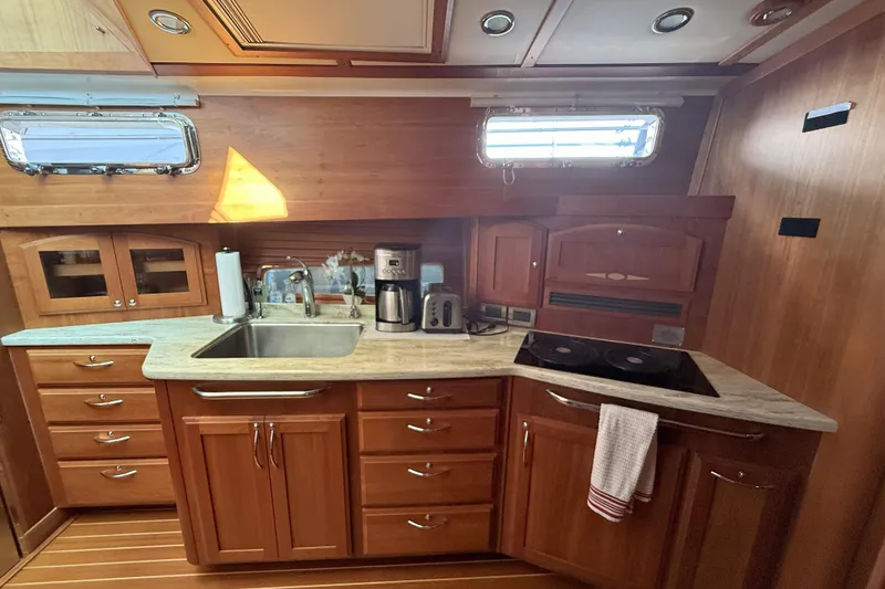 Haggis Xx Yacht Photos Pics 2017 Sabre 48 Salon Express kitchen with wooden cabinetry, sink, and appliances.