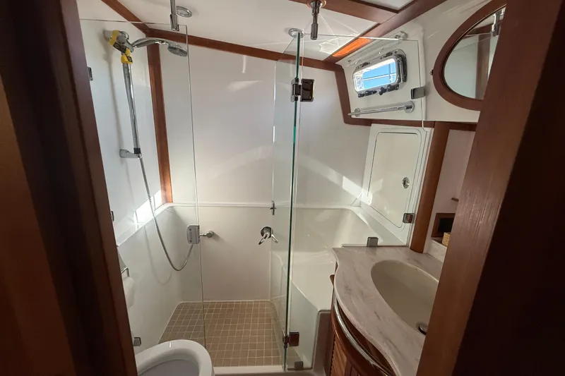 Haggis Xx Yacht Photos Pics Luxurious bathroom in 2017 Sabre 48 Salon Express yacht with glass shower and modern fixtures.