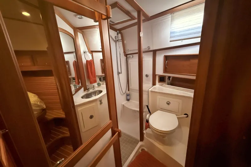 Haggis Xx Yacht Photos Pics Bathroom interior of 2017 Sabre 48 Salon Express yacht, featuring wood accents and modern fixtures.