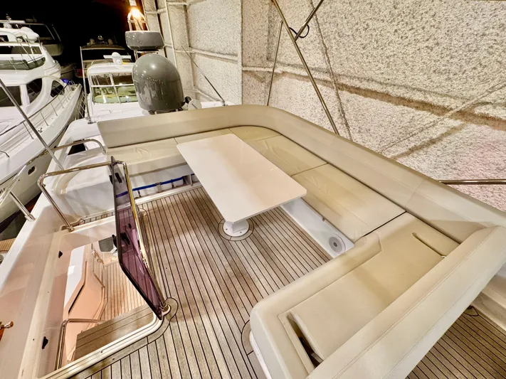 Time To Fly Yacht Photos Pics Luxurious seating area on 2022 Ferretti Yachts 550, featuring elegant design and spacious layout.