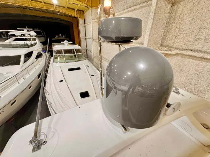 Time To Fly Yacht Photos Pics 2022 Ferretti Yachts 550 in a marina, surrounded by other luxury boats.