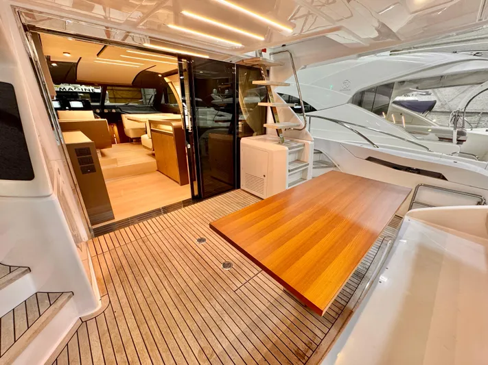 Time To Fly Yacht Photos Pics Luxurious 2022 Ferretti Yachts 550 interior with elegant wood finishes and modern design.