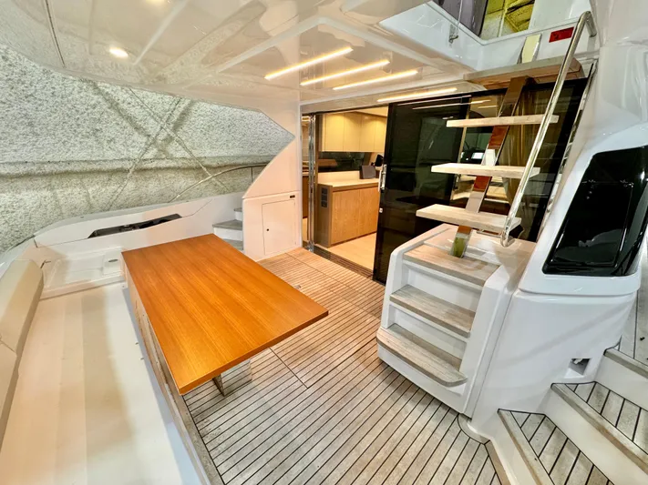 Time To Fly Yacht Photos Pics Luxurious 2022 Ferretti Yachts 550 interior with wooden table and modern design.