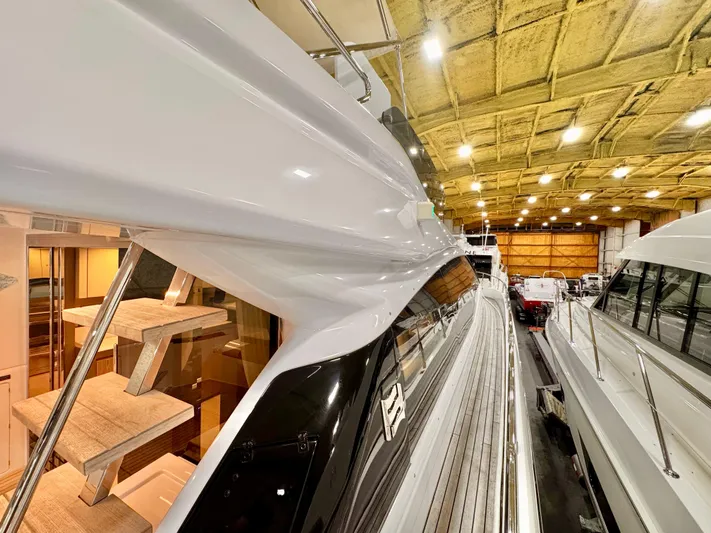 Time To Fly Yacht Photos Pics 2022 Ferretti Yachts 550 in a well-lit indoor showroom, showcasing sleek design and craftsmanship.