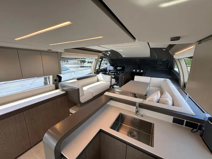 Time To Fly Yacht Photos Pics Luxurious interior of 2022 Ferretti Yachts 550, featuring modern design and spacious seating.