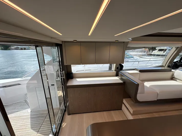Time To Fly Yacht Photos Pics Luxurious interior of 2022 Ferretti Yachts 550, featuring modern design and waterfront view.