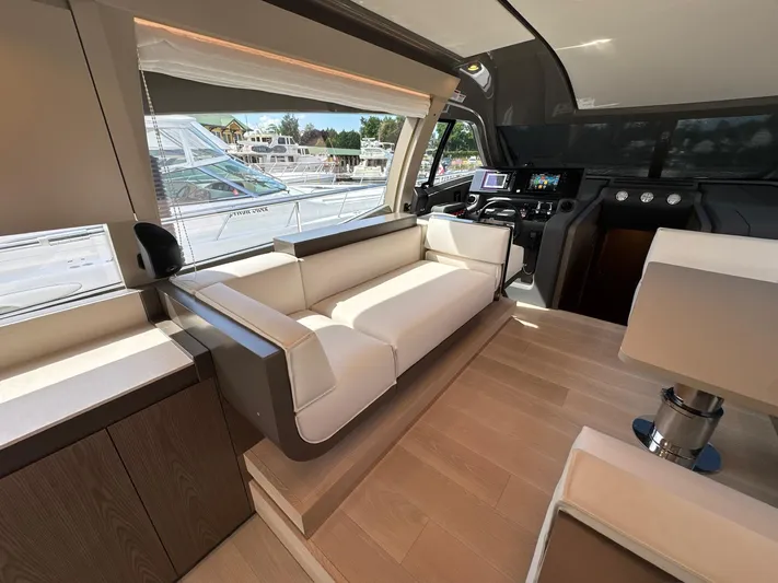 Time To Fly Yacht Photos Pics Luxurious interior of 2022 Ferretti Yachts 550, featuring elegant seating and modern navigation controls.