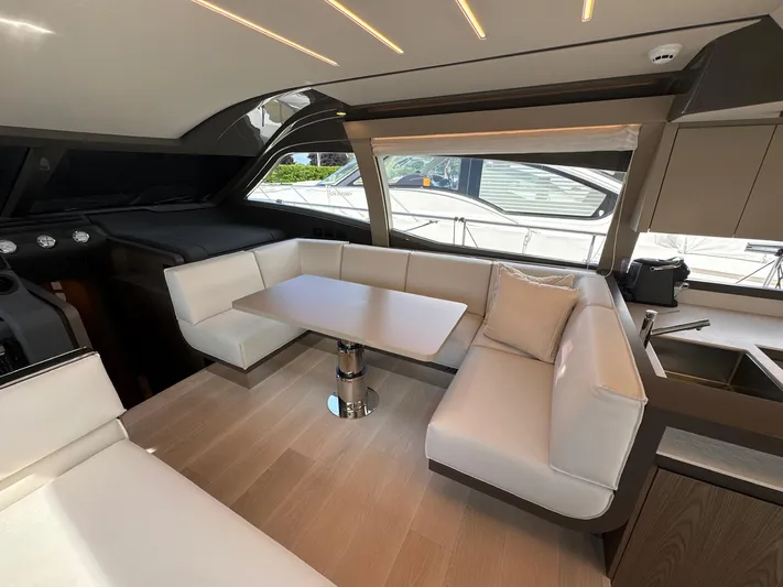 Time To Fly Yacht Photos Pics Luxurious interior of 2022 Ferretti Yachts 550 with elegant seating and modern design.